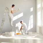 Team,Of,Professional,Painters,In,White,Clothes,Painting,A,Grey