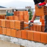 Worker,Builds,A,Brick,Wall,For,House,Construction.,Worker,Building